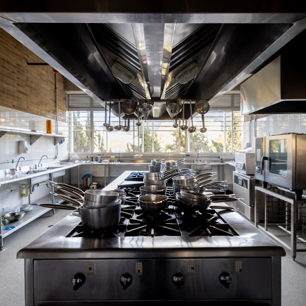 Professional kitchen with pans and pots on the central island